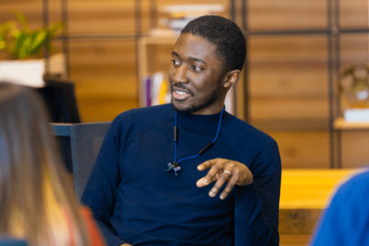 Young man in a blue jumper.