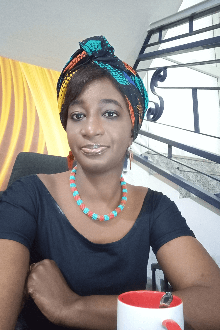 A woman with a blue top and multicolored head scarf. 